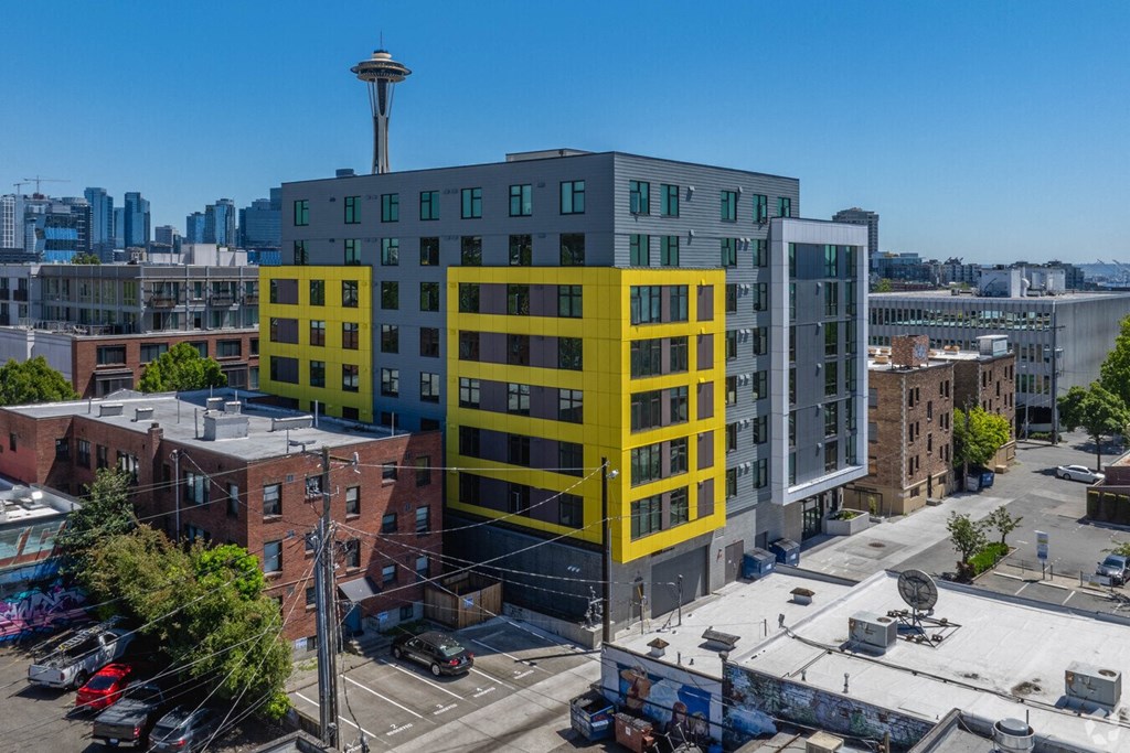 an aerial view of a yellow building in the city