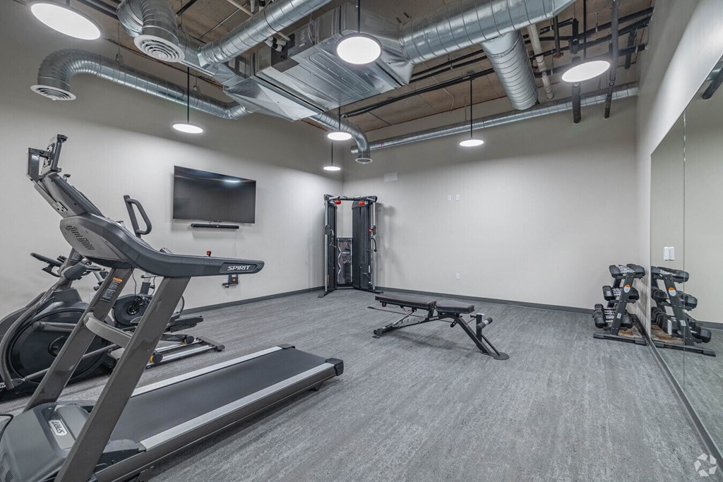 the gym at the district flats apartments in lenexa