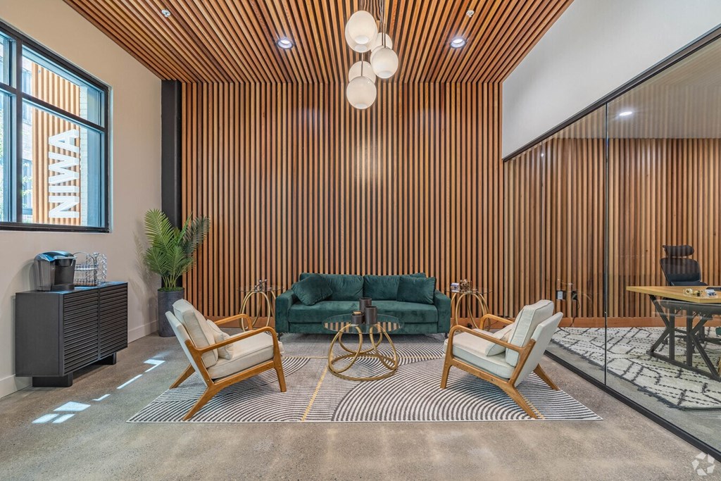 a living room with a green couch and two chairs