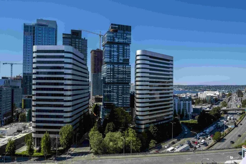 A cityscape with modern buildings and a clear sky.