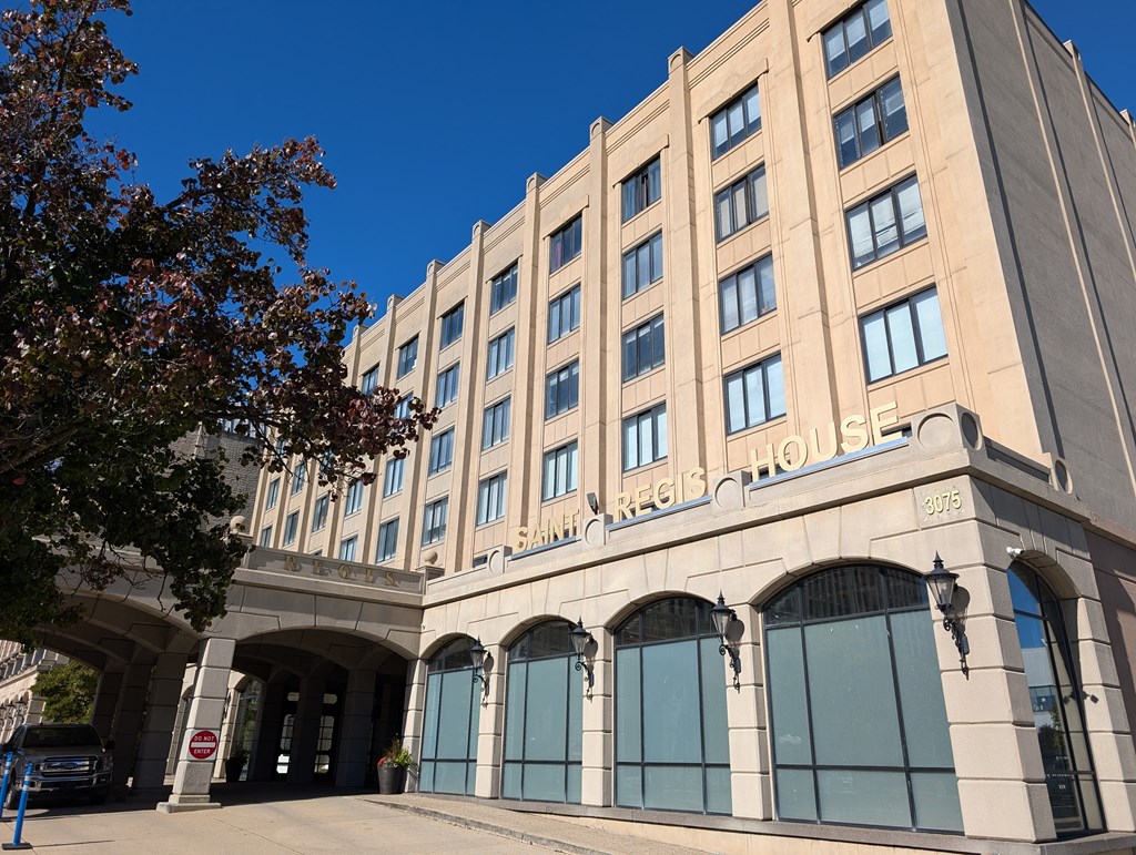 a large building with a tree in front of it