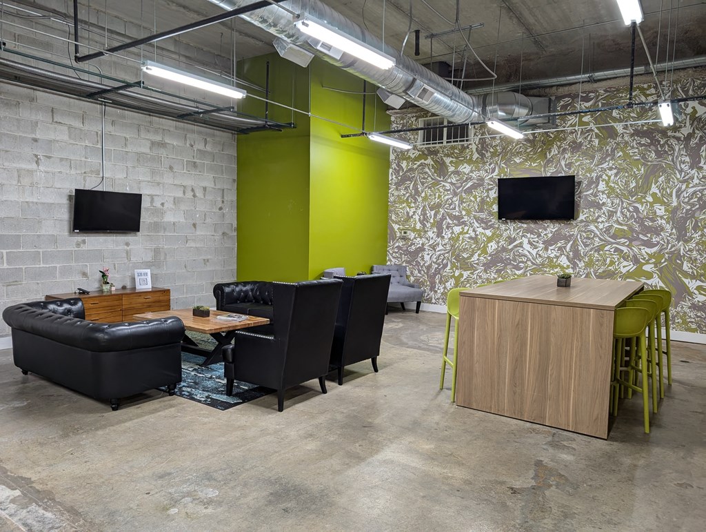 a living room with couches and chairs and a table and a tv
