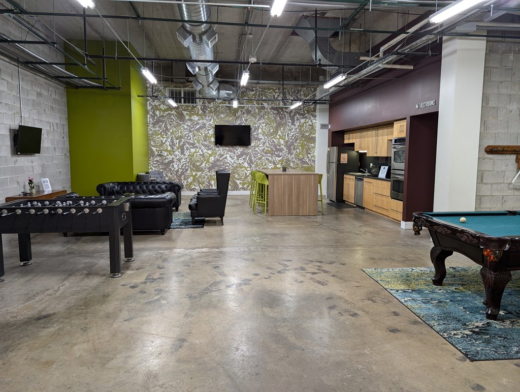 a game room with a pool table and a tv