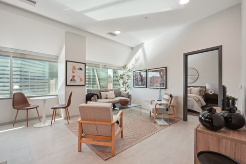 A living room with a brown chair and a white couch.