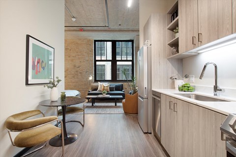 A modern kitchen with a dining table and chairs.