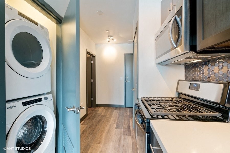 a laundry room with a stove and a washer and dryer