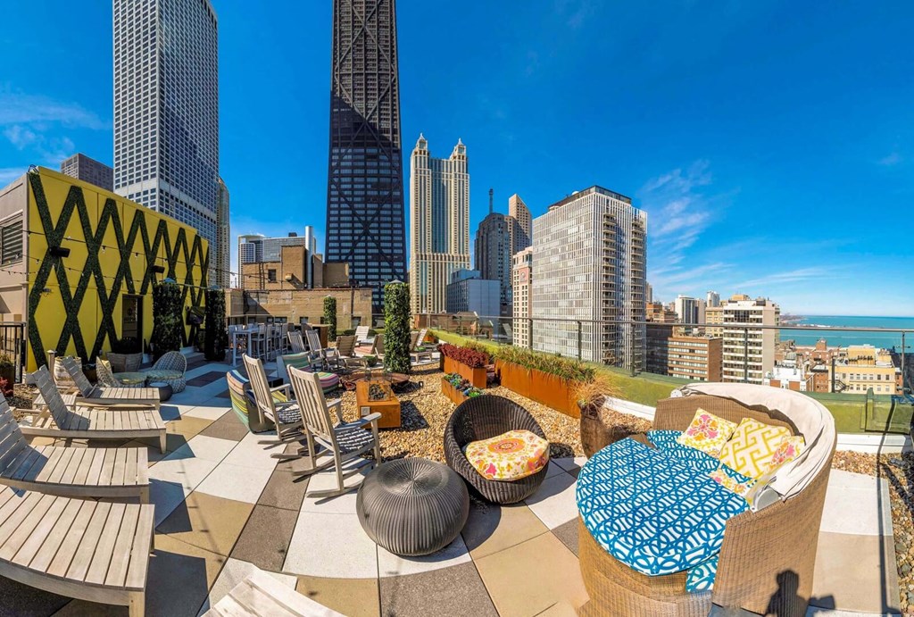 a rooftop patio with a view of the city and the ocean