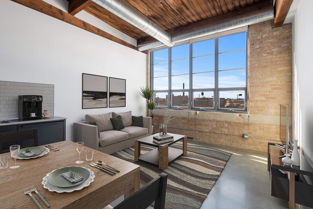 a living room with a couch and a table and a large window