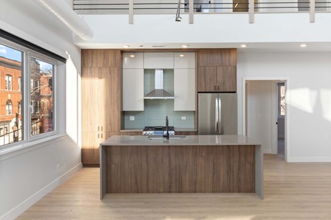 a kitchen with a large island and wooden cabinets