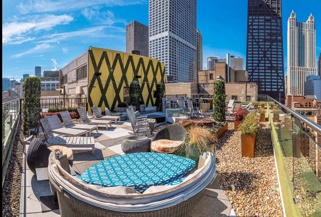 a rooftop lounge with a city skyline in the background