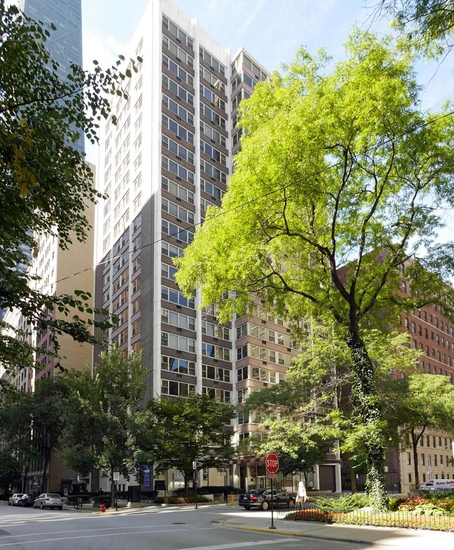 a tall building on the corner of a city street
