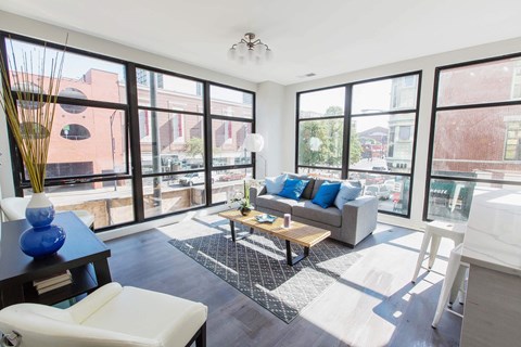 a living room with large windows and a couch