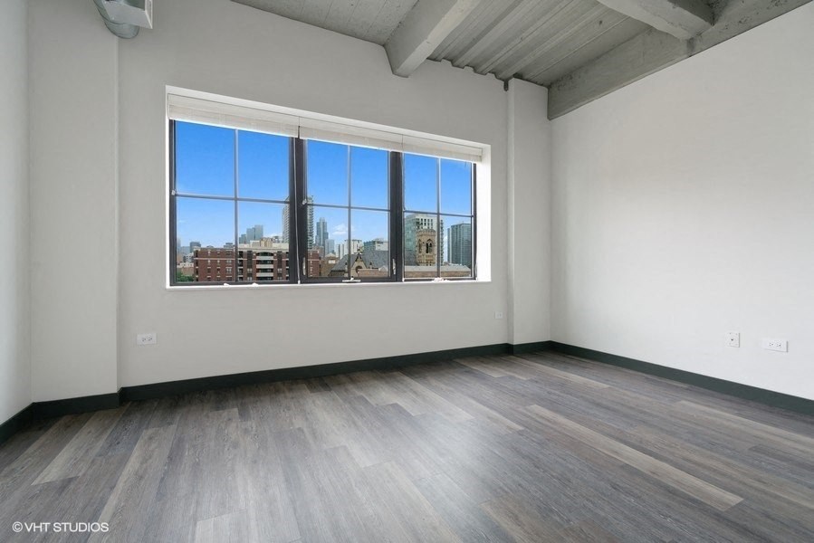 an empty living room with a large window