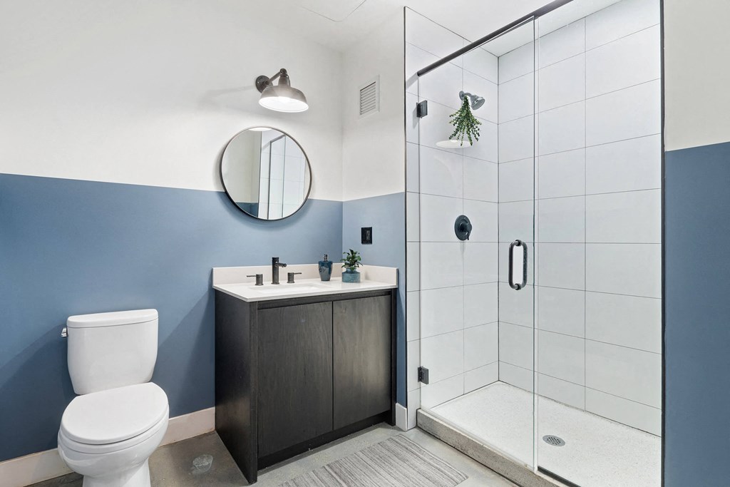a bathroom with a toilet sink and shower