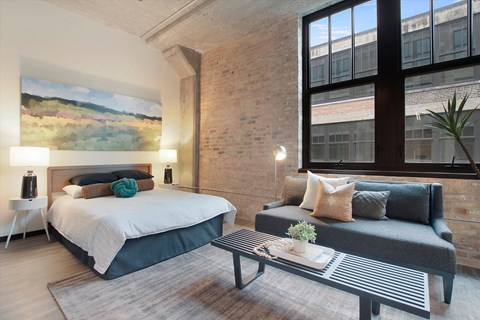 a bedroom with a bed and a couch in a loft