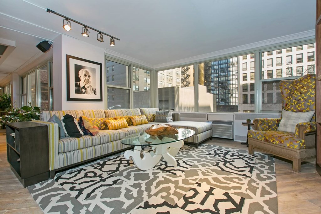 a living room with a couch and a glass coffee table