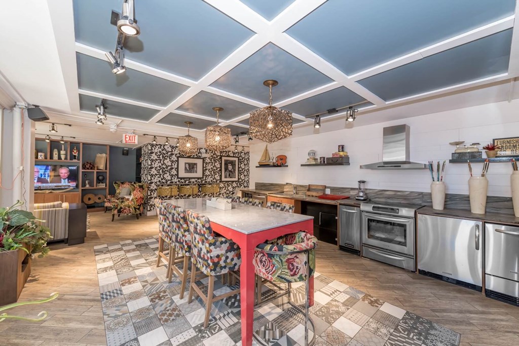 a kitchen and dining room with a long table and counter tops