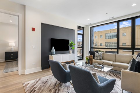 A modern living room with a grey chair in the center.