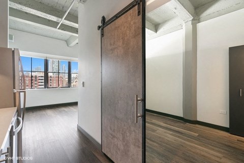 a sliding barn door in an empty room with a window