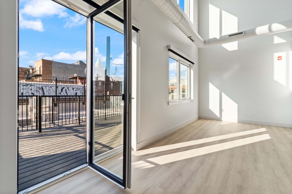 a view of a balcony from a living room with glass doors