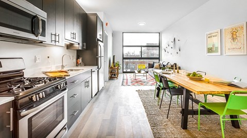 a kitchen with stainless steel appliances and a wooden table