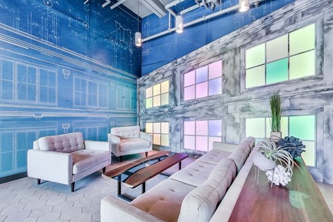 a living room with blue walls and a couch and chairs