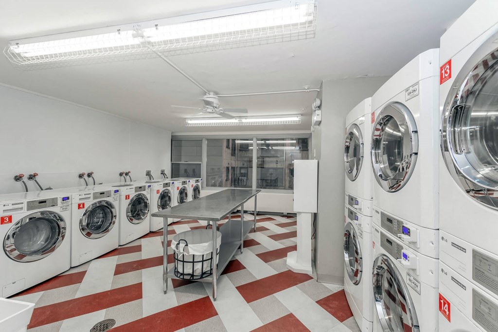a washer and dryer room with washing machines and a table