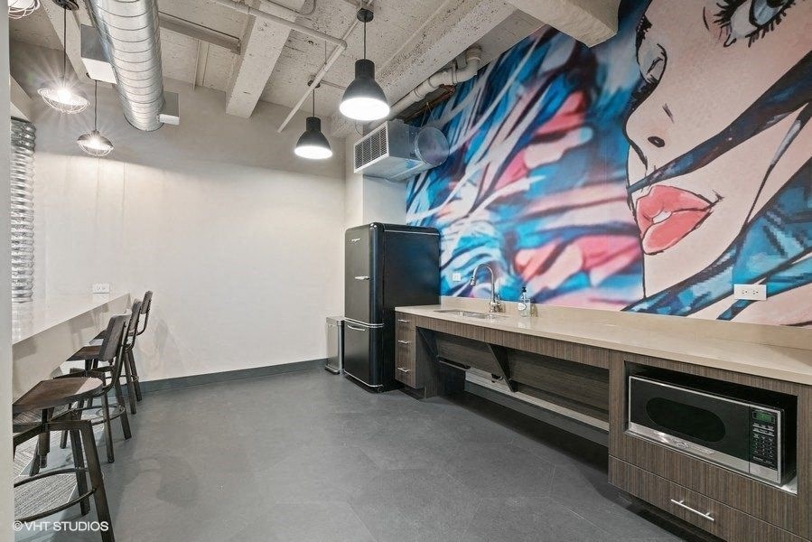 a kitchen with a counter and a mural on the wall