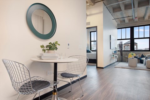 A modern dining room with a white table and chairs.