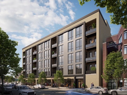 A modern apartment building with cars parked in front.