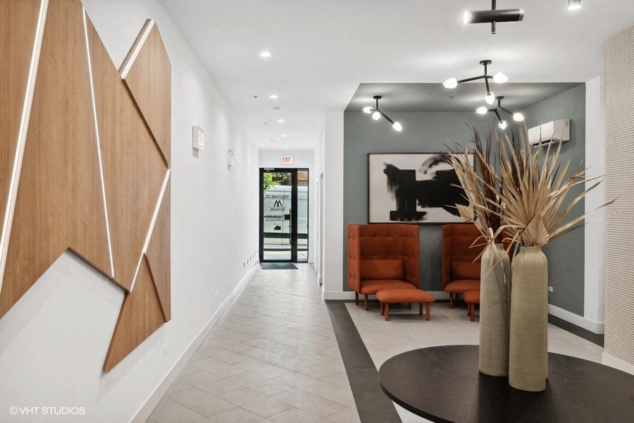 A modern interior with a wooden panelled wall and a black table with a vase on it.