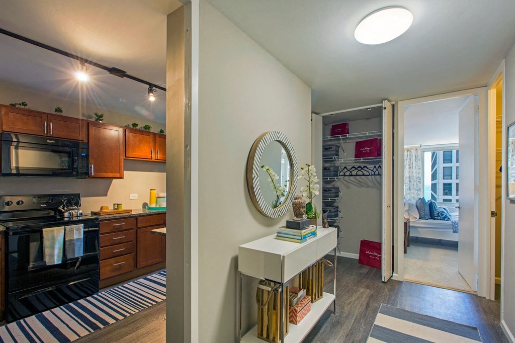 a view of a living room and a kitchen with the door open