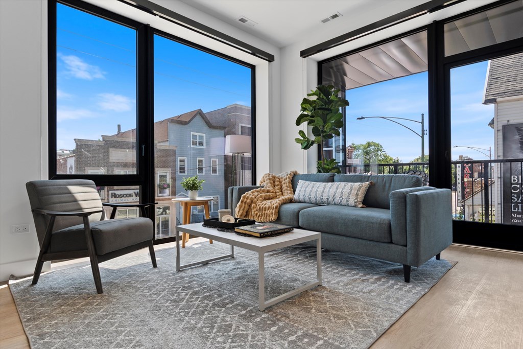 A living room with a grey couch, a chair, and a coffee table.