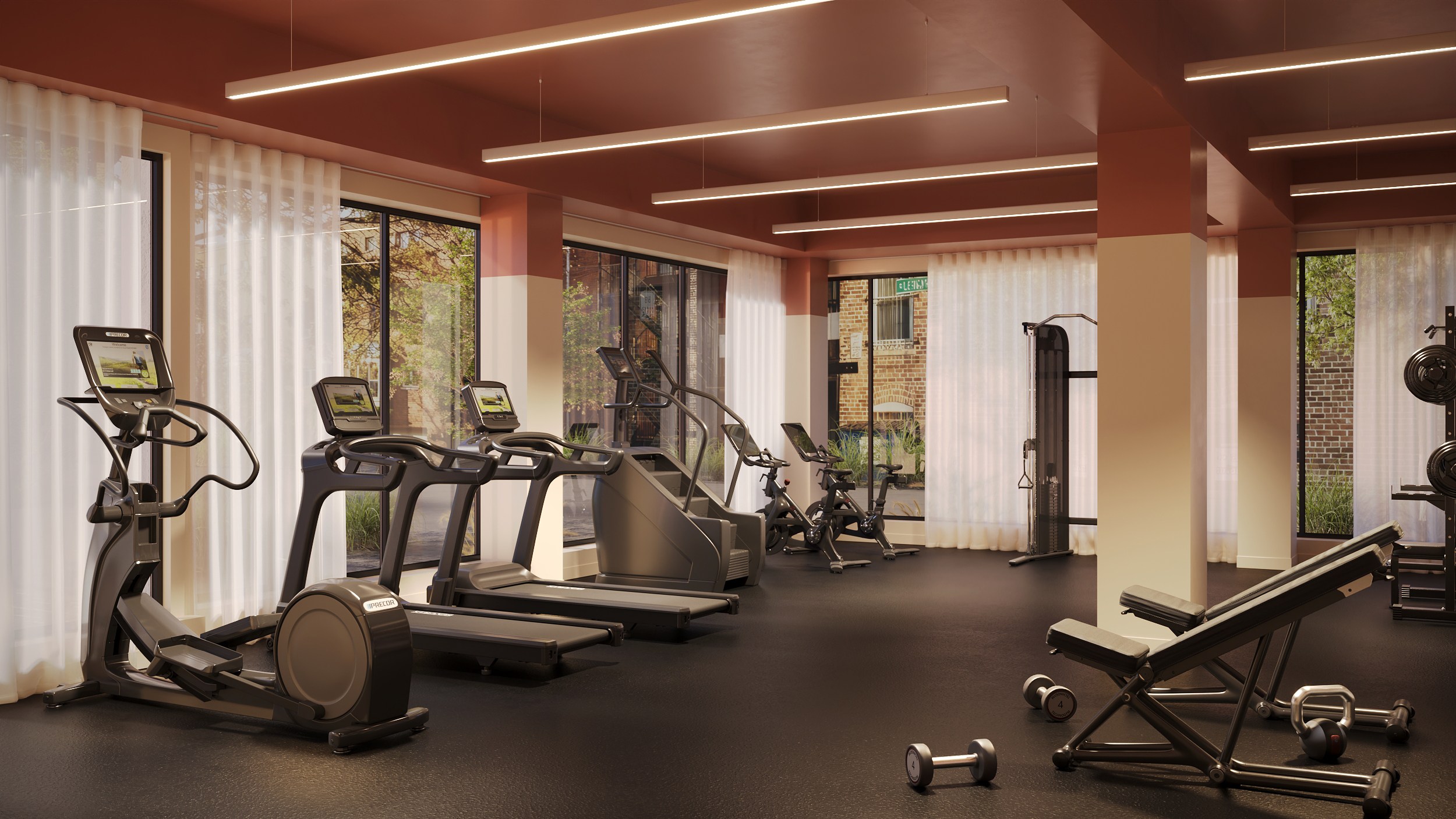 A gym with treadmills, exercise bikes, and dumbbells.