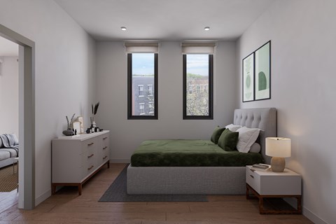 A bedroom with a bed, nightstand, and window.
