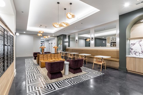 A modern lounge area with a patterned carpet and wooden furniture.