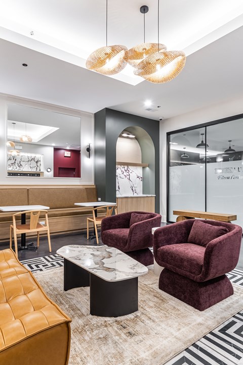 A modern living room with a maroon chair and a wooden coffee table.