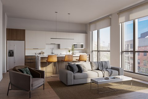 A modern living room with a grey couch, a brown armchair, and a white coffee table.