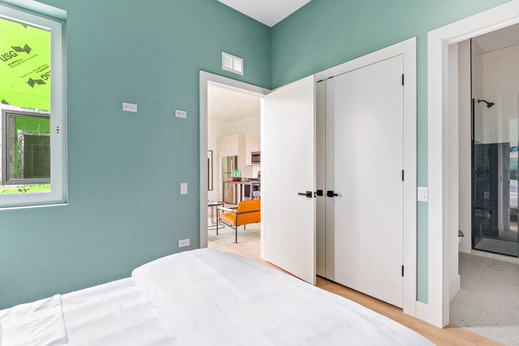 A bedroom with a bed and a wardrobe.