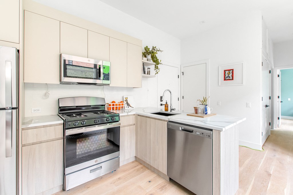 A kitchen with a stove, oven, and refrigerator.