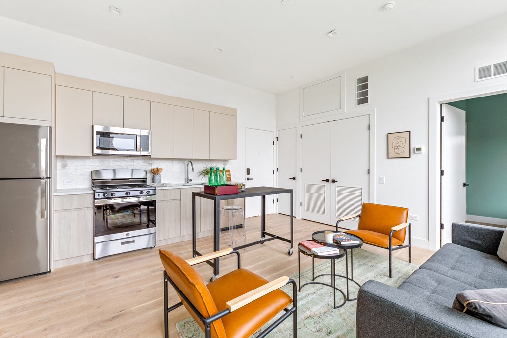 A kitchen with a table and chairs in the middle of the room.