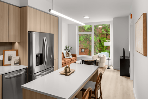 A modern kitchen with a large island and stainless steel appliances.