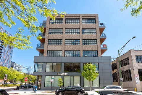 A modern building with the word "PEACHY" on the front.