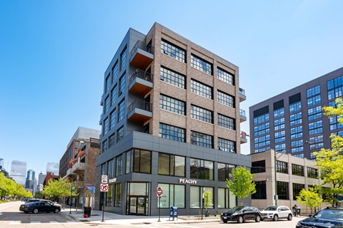 A modern building with the word "Peachy" on the front.