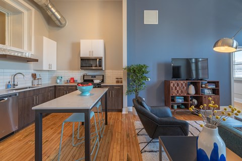 A modern kitchen with a dining table and chairs.