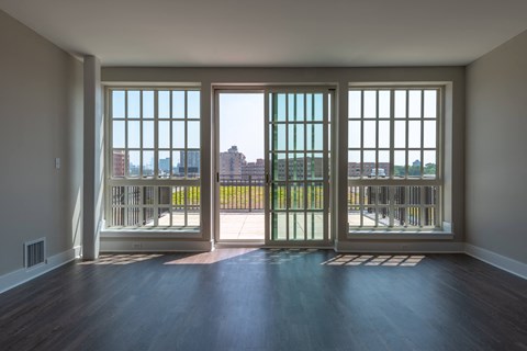 A room with a view of the city through large windows.