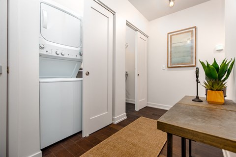A white fridge in a kitchen with a brown mat on the floor.