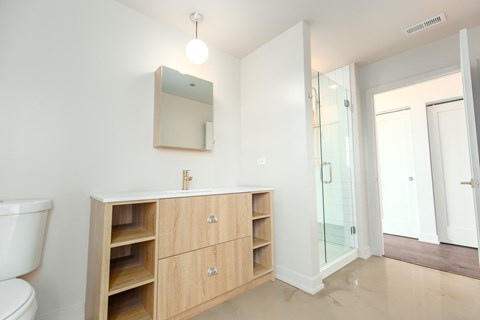 A bathroom with a sink, mirror, and toilet.