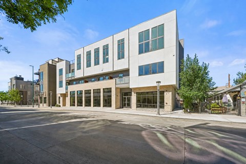 A modern building with a white facade and large windows.