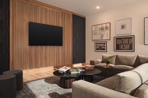 A living room with a flat screen TV mounted on the wall above a coffee table.